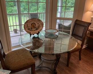 Across from kitchen - round glass top table with 2 chairs
