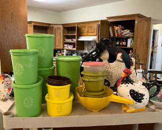 Kitchen - green Tupperware cannisters - set of 4 with an additional extra-large canister. Chicken, yellow Tupperware lidded bowls, large platter in very back on stand.