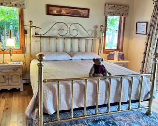 VIEW OF ONE OF THE BEDROOMS SHOWING HOME DECOR, BEDSPREAD, RUG, NIGHT STANDS ANE LAMP.