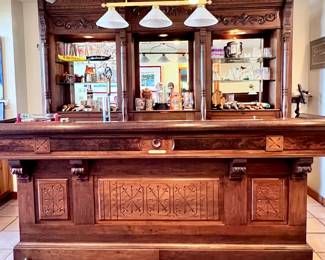 WOW!! Home Bar! Ornate Victorian-Style Carved Wood. Front Bar with Brass Foot Rest. Back Bar with Lighted Compartments, Glass Shelves, Drawers and Cupboards.