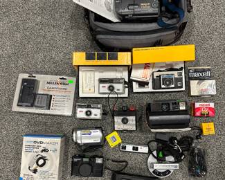 Sony HandyCam Vison Video 8 with Bag & Accessories; Kodak Instamatic X-15 Color Outfit in Box; Kodak Instamatic 104 Color Outfit in Box; Kodak Instamatic 104 Camera; Polaroid Spectra AF ; Savoy Camera; Sony Handy Cam HDD DCSR40 with Tags; GAF Personal 2 Camera; Rechargeable Millennium Power System Camcorder Battery & Charger; Tevion High Speed DVD Maker; Mamiya 135 EF Camera; Casio LCD Digital Camera DV-70; Kodak Easy Share V550 and Docking Station; Kodak Mini Charger AA or AAA; JcPenney Telephoto Pocket Camera w/ Elec Strobe; Maxwell Mini DV Tapes; Kodak Close Up Attachement #13
