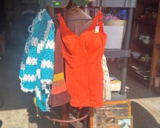 Coat Rack; Vintage Orange Swimming Suit; Hand Made Crochet Ponchos/Caapes; Baseball Caps; Wooden Magazine Rack; Pictures