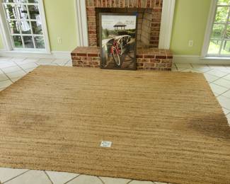 Straw-like area rug. NOTE: 2 stains as pictured. $25.00