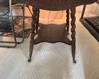 Antique Oak Parlor Table – carved apron – Turned legs with wheels feet – original finish. Measures 24″ x 24″ top, 28 1/2″ height. Circa 1900.