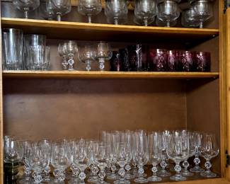 Check out that top row with the Mid Century chrome and crystal shrimp cocktail glasses, two part for crushed ice to keep the shrimp chilled! And lots of elegant barware from balloon snifters, carved cranberry glass tumblers, and a large set of gracefully formed champagne flutes, water goblets, wine glasses