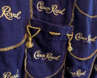 Closeup of the one-of-a-kind treasure for Crown Royal enthusiasts: A zip front and lined jacket hand-crafted from Crown Royal bags. Note how the two front pockets are decorated with the gold drawstring cord!