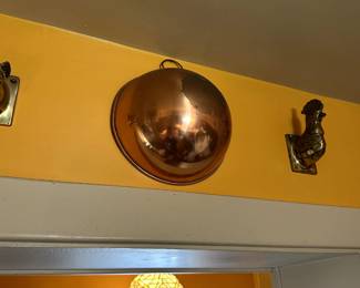 A round base copper and brass mixing bowl with rolled rim and thumb ring