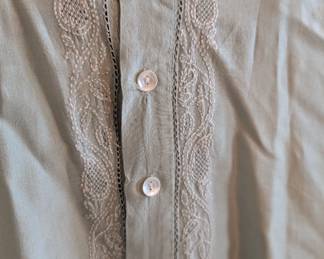 Closeup of men's light grey/blue tunic shirt with embroidered placket