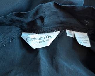 Closeup of Christian Dior Monsieur black belted silk robe with red piping