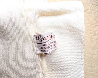 Closeup of Gucci monogram white silk scarf