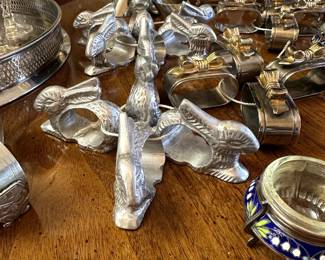 Stylish table décor - rabbit shaped pewter napkin rings, silver and gold metal ribbon/bows napkin rings, and a set of beautiful vintage 1960s/1970s Russian white metal and enamel salt cellars with removable glass bowl inserts. Enamel has white snowdrop blossoms on a dark blue background.