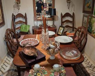 Dining table and chairs, area rug, framed original art, large decorative serving platters, vintage bronze wall sconces