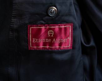 Closeup of vintage men's Etienne Aigner black suit coat or sport jacket, lined, three-button closure, made in Russia