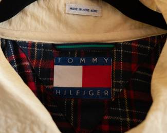 Closeup of vintage men's Tommy Hilfiger cream color long coat or trench coat, lightweight material