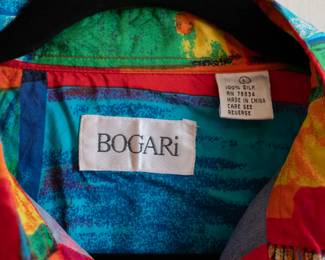 Closeup of vintage Bogari men's silk short sleeve shirt in vivid tropical abstract pattern, size L