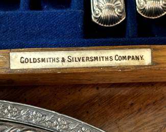 Closeup of antique Victorian silver plated King's Pattern fish cutlery for twelve. Housed within its original oak fitted case with blue satin and velvet interior. Each knife and fork is marked for the Goldsmiths & Silversmiths Co., London, England.