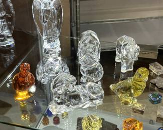 Baccarat crystal figurines including a Nativity Angel, a Baccarat yellow crystal parrot figurine paperweight, a Baccarat crystal topaz yellow mini frog figurine, Baccarat elephant, and more...