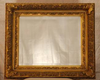 A beveled mirror in vintage style frame