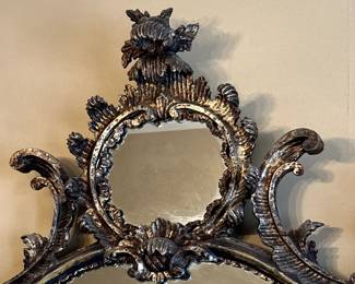 Close view of the top of the gorgeous pierce carved polychrome giltwood rococo style mirror, ornately pierce carved with foliate and leaf scrollwork