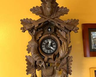 A vintage German Black Forest hunting scene cuckoo clock