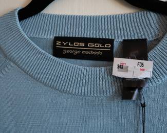 Closeup of Zylos Gold George Machado light blue long sleeve crew neck sweater