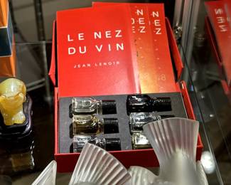 A Jean Lenoir Le Nez Du Vin wine aroma kit (seen behind 2 of the 4 Lalique Crystal sparrow figurines)