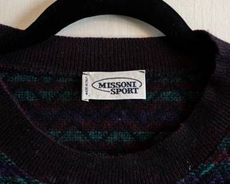 Closeup of Missoni Sport black, green, red patterned pullover long sleeve sweater, made in Italy