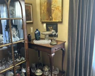 Antique display cabinet; a pair of vintage Queen Anne style tea tables with two pull out candle stands on their ends; Frank Willett Studio footed compote, unique and original framed artwork; Napoleon Brandy balloon snifters