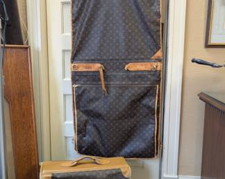 A vintage Louis Vuitton monogram garment bag and vintage 1970s Louis Vuitton pullman suitcase