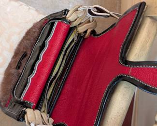 Another view of stylish designer cross-body handbag featuring full grain and patent leather and genuine fur. Accordion expansion offers ample storage and organization.