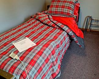 Hospital bed with electronic control and removable side rails. Bedding included