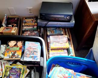Huge collection of DVDs, VHS tapes as well as VHS and DVD players