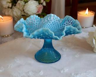 Make your centerpiece at your next table setting or your next event something special and unique! Large Antique footed Fenton blue hobnail opalescent ruffled Edge compote.