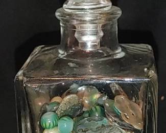 Beautiful old antique perfume bottle filled with mother of pearl pearls and antique glass beads