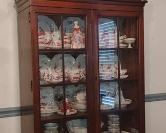Beautiful mahogany china cabinet with pewter and silver on top of cabinet