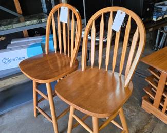 Two Oak Colored Wood Bar Stools that Swivel