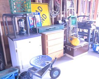 Air Hoses; Two Storage Cabinets; 2 Glass Top Patio Tables; Garden Stool Cart; Coleman Lantern; Old Metal Signs and Plastic Crates