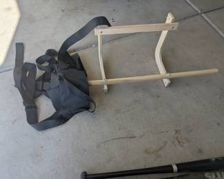 Back Stretcher. You put the wooden part on a door frame and you sit in the black part and then it acts like a traction device. $40