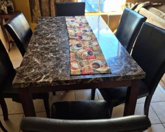 Faux marble table with 6 cushy faux leather seats. Most comfortable in the house.