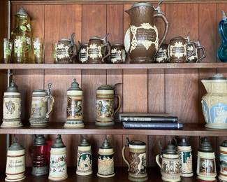 Large collection of German beer, pitchers, and Steins, including Metttlach