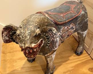 Another view of carved wooden pig sculpture.