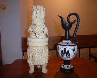 Vintage Chinese Carved Resin Buddha, Foo Dog Tower Represents a blend of religious and protective symbolism, drawing from Chinese Buddhist and Feng Shui traditions; 14" H                                                                                                          Vintage Grecian Design Pottery Pitcher/Ewer  
Hearts & Warrior/ black & white motif; 12.5” H
