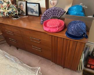 close up of mid century modern dresser with mirror, vintage hats