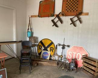 VINTAGE Railroad sign, stop sign and NASA sign. Antique weather vane parts, vintage wooden & iron foldout ironing board. Two Vintage wood game boards. Several antique uses. Old metal kitchen faucet lid out step stool