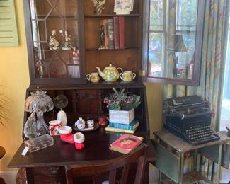 Beautiful European secretary, Antique L.C. Smith typewriter sitting upon old metal typewriter stand