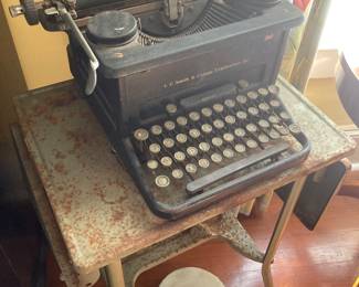 Antique L,C. Smith typewriter plus an vintage metal typewriter table