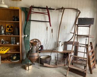 Primitive bench (England), vintage wooden ladder, rug beaters, antique brass & copper seed separator, cast iron fire grate, vintage fall out shelter sign, and many other vintage items.