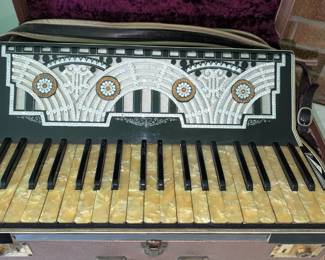 Unmarked accordion with inlaid rhinestones and case.