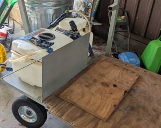 Small trailer with yard sprayer.