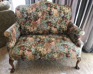 Victorian style loveseat with floral tapestry pattern upholstery